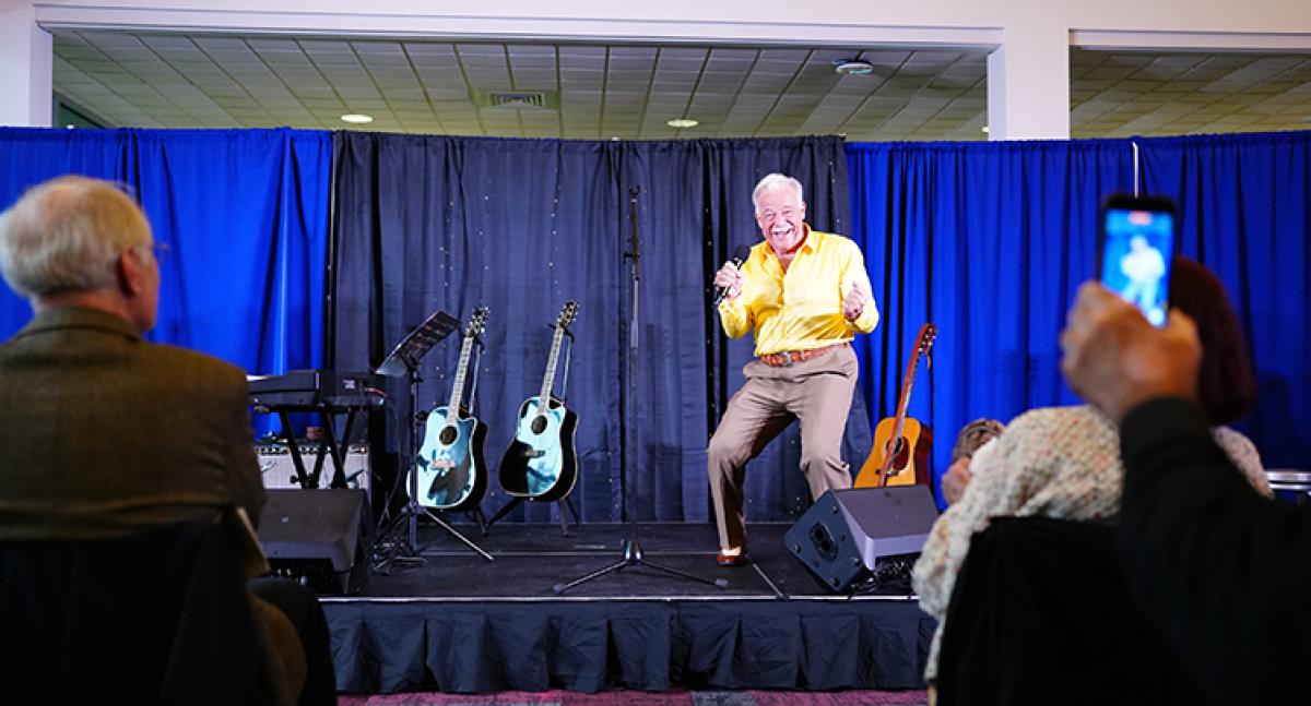 A man performs a song on stage