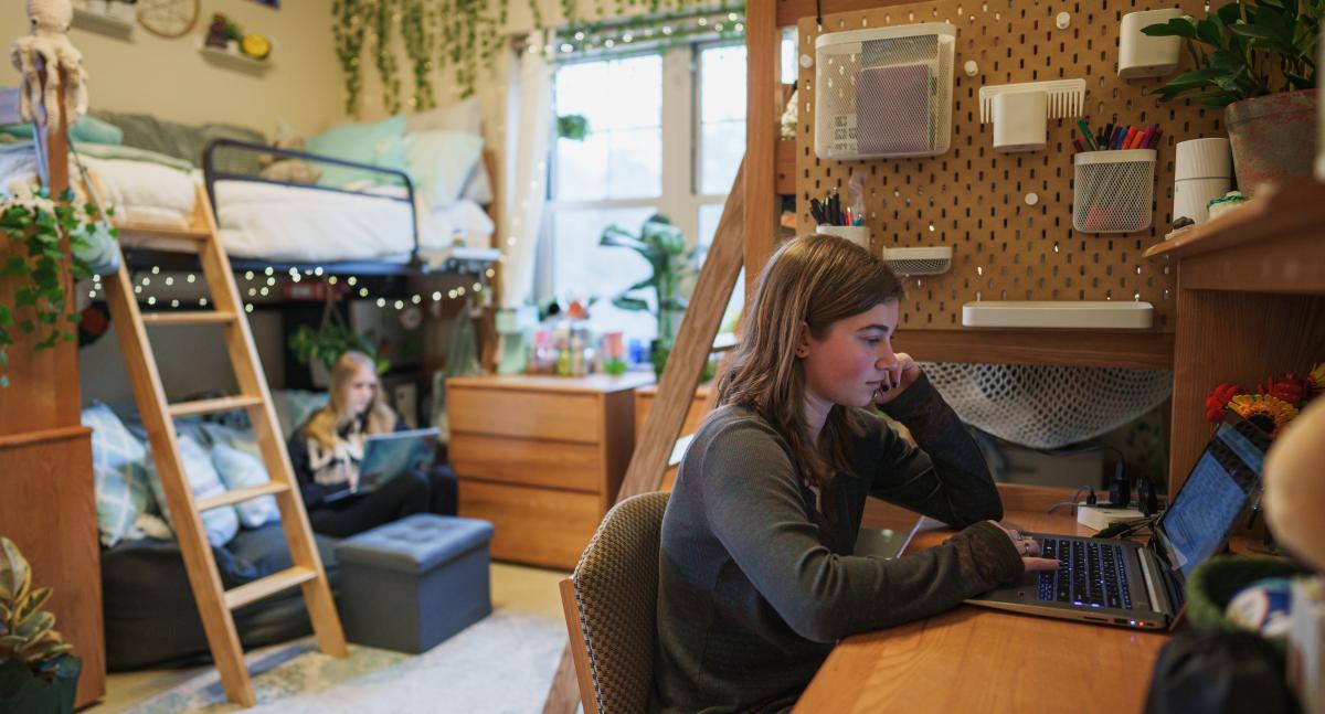 photo of student at desk in dorm