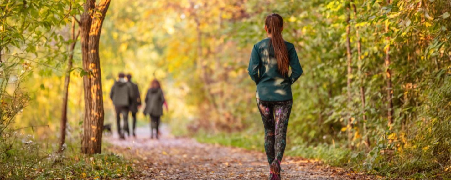 Woman walking on a trail in a park