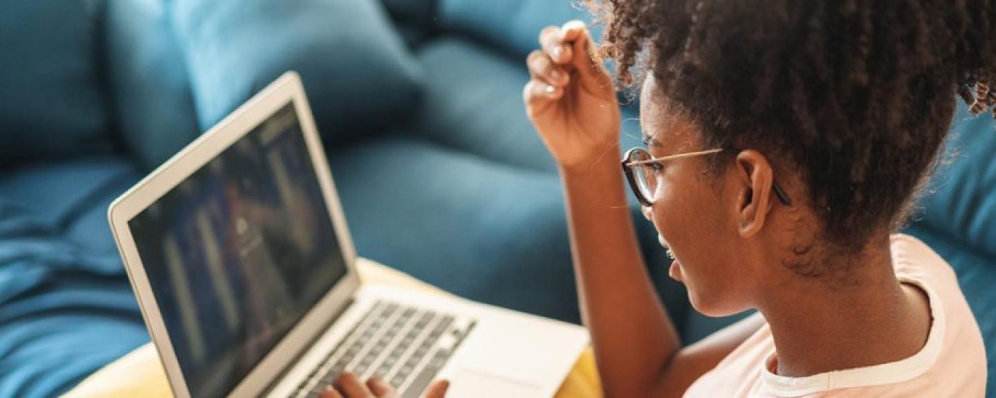 Motivated student working comfortably on a laptop