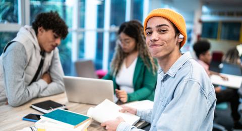 Stock photo of three students working at a table