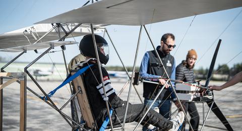 Male student in the cockpit of an ultralight aircraft designed by a team of UNH students