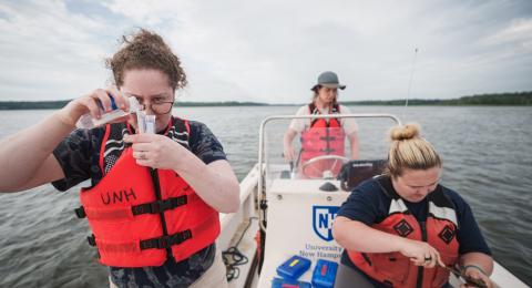 UNH research students in a boat 