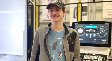 Joe Aubut stands my cnc machine at the Olson Center