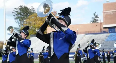 UNH student Katherine Matczak on the field playing in the UNH Marching Band