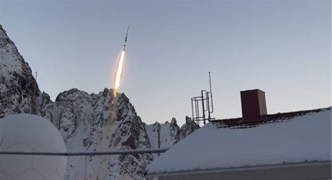 Rocket launches above a snowy scene.