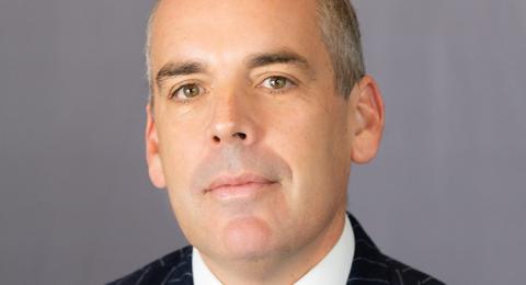 Portrait of Robert Watling in a pin-striped suit coat and burgundy and blue tie
