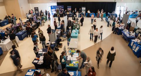 time lapse photo from above of a crowd at a career fair