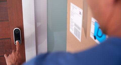 Man presses video doorbell 