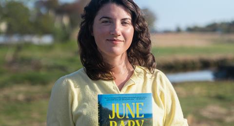 Portrait of Shannon Garvey holding a copy of "June Baby"