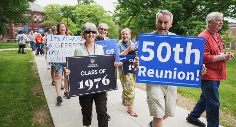 UNH alumni walk in a parade during reunion weekend