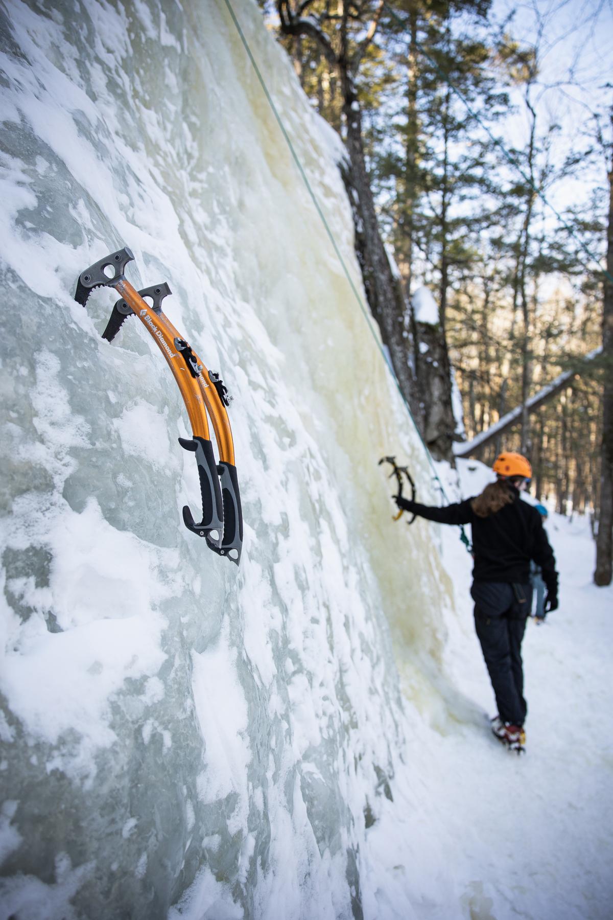Ice climbing tools stuck into an ice sheet