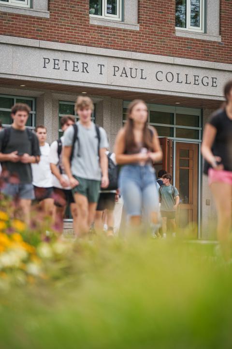 two college students walking in from of the UNH Paul College of Business and Economics