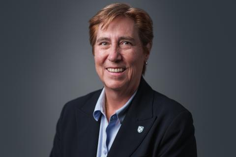 New UNH provost Jeanette Riley poses for a photo in front of a gray background