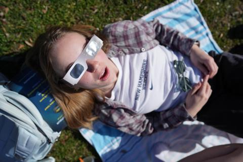 Student looking at the solar eclipse