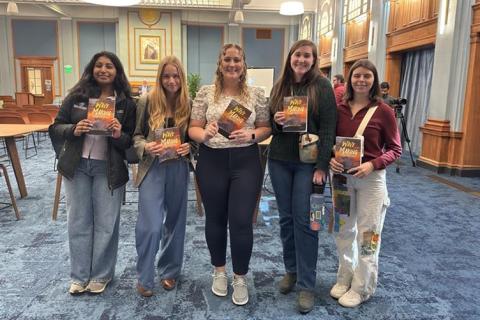 UNH students with copies of David Shaw's new book, "Wave Making: Inspired by Impact."