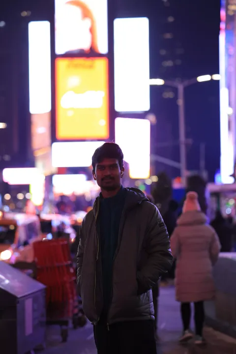 Ramesh standing outside smiling at camera