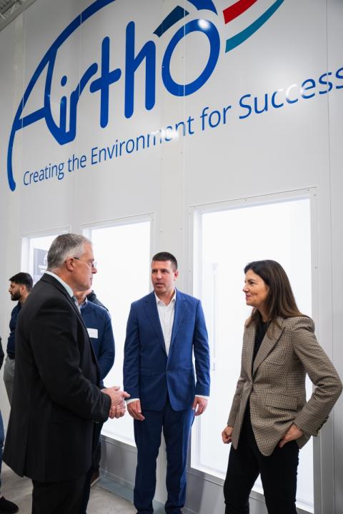 Airtho President Brandon Bogart (center) shows the cleanroom to Olson Center Director John Roth and Governor Kelly Ayotte.