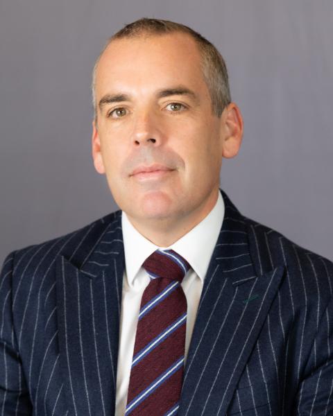 Portrait of Robert Watling in a pin-striped suit coat and burgundy and blue tie