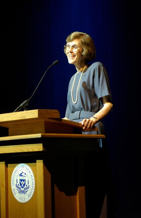 Former UNH President Joan Leitzel speaks at a podium with the university seal on the front