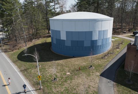 Aerial view of UNH's Thermal Energy Storage Tank, a blue and white cylindrical structure