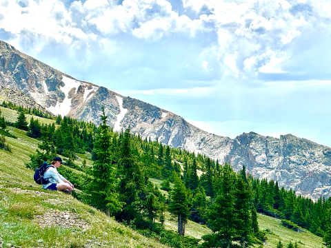 person sitting on a mountainside
