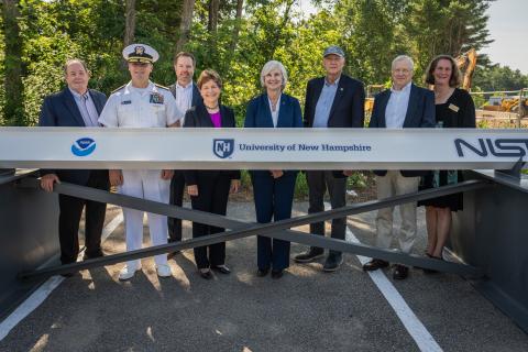 Sen. Jeanne Shaheen and UNH and NOAA leaders stand behind a ceremonial construction beam.