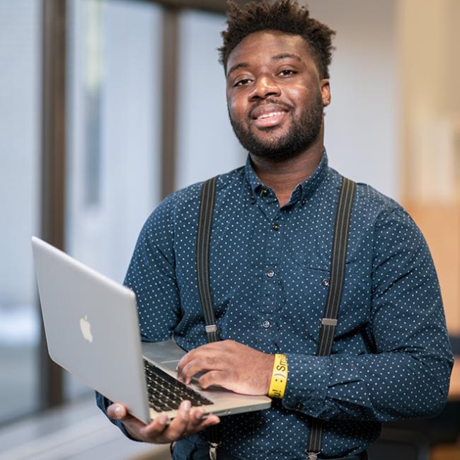 man holding a laptop