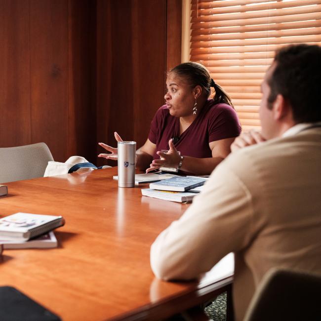 law student sitting at table in conversation