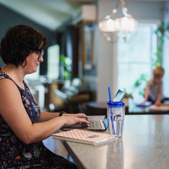 UNH online student on laptop at home